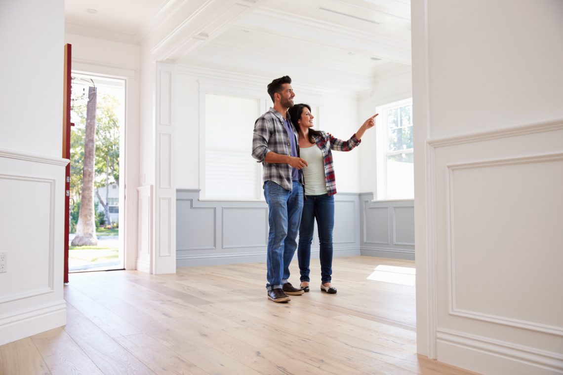 Hispanic Couple Viewing Potential New Home